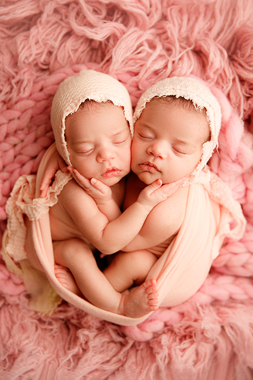 sleeping and sweet newborn twin sisters