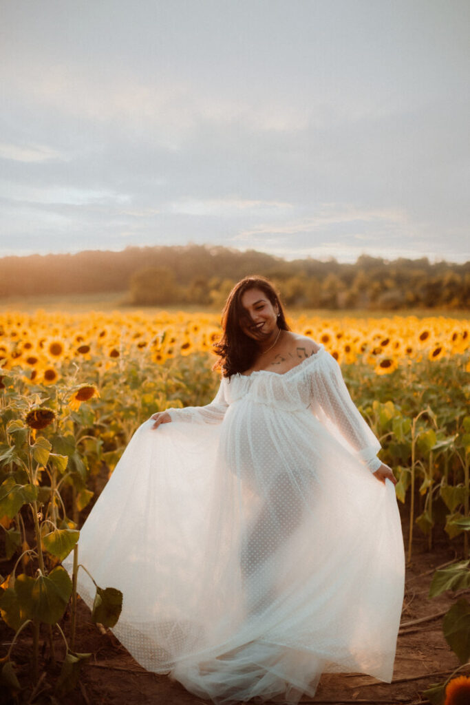 maternity photo shoot outdoors in sunflower field