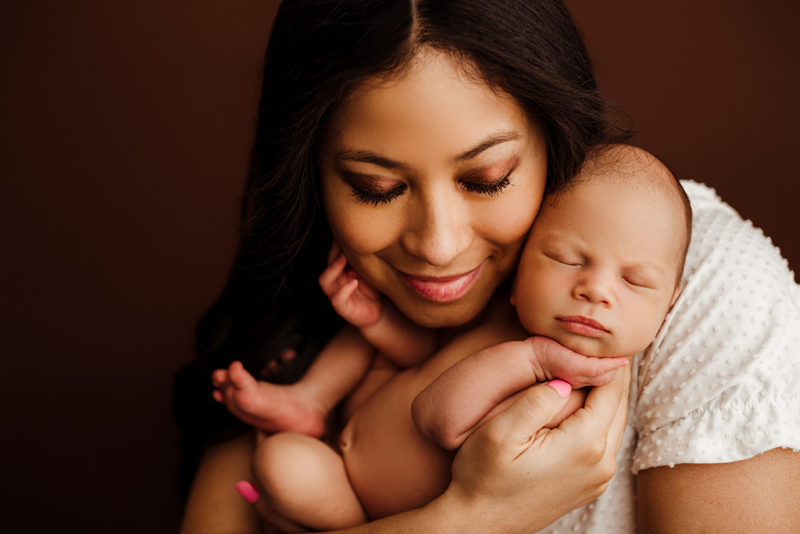 mother and son newborn photography pose