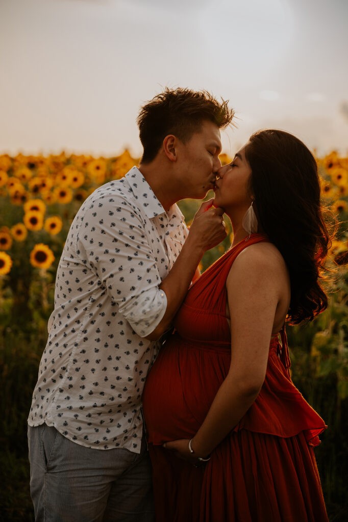 gorgeous expecting couple in sunflower field