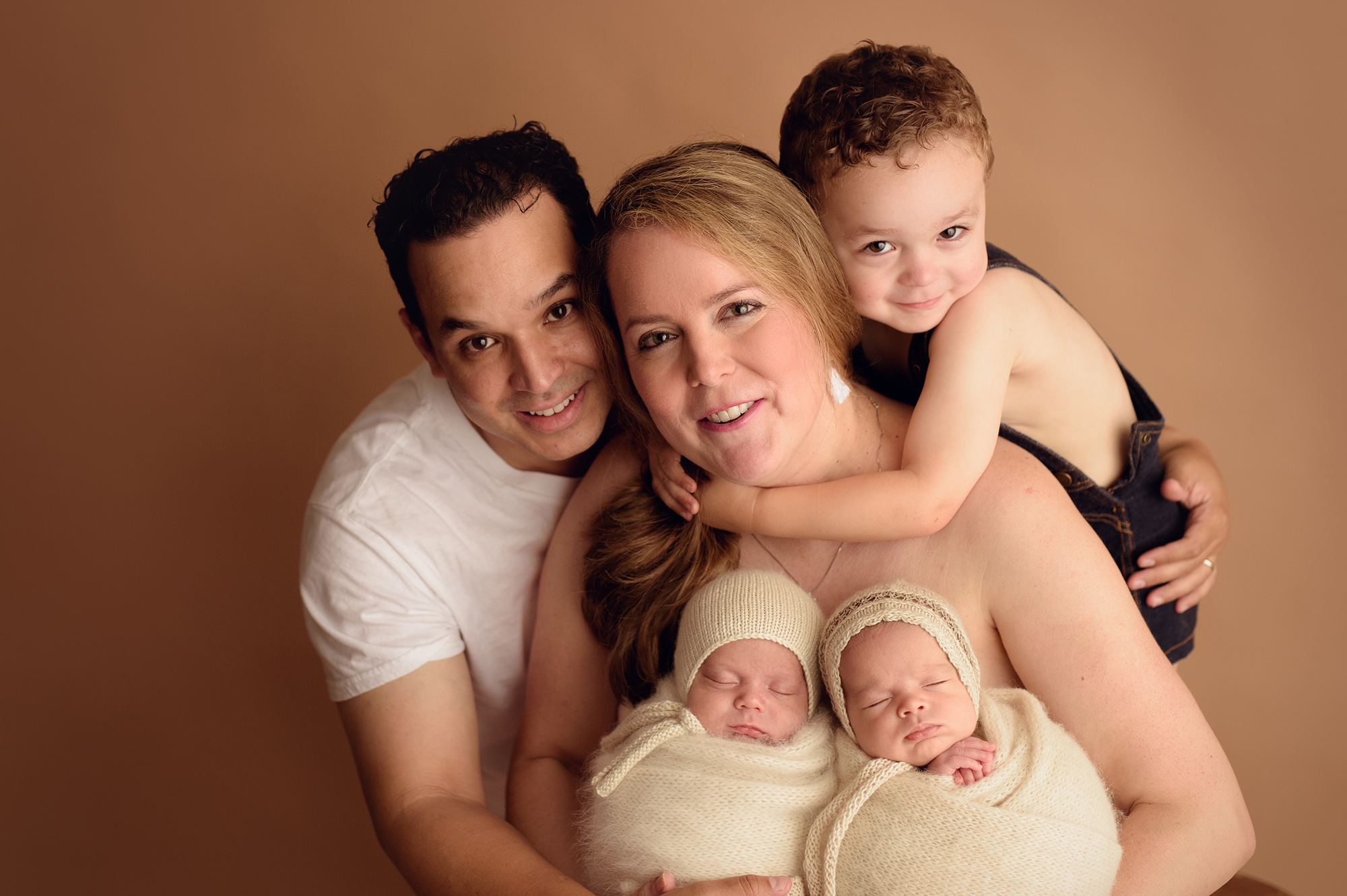 family posing with newborn twins