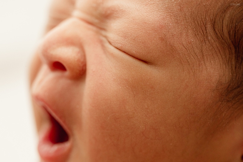 Newborn Photographer, a little baby yawns, eye's still closed