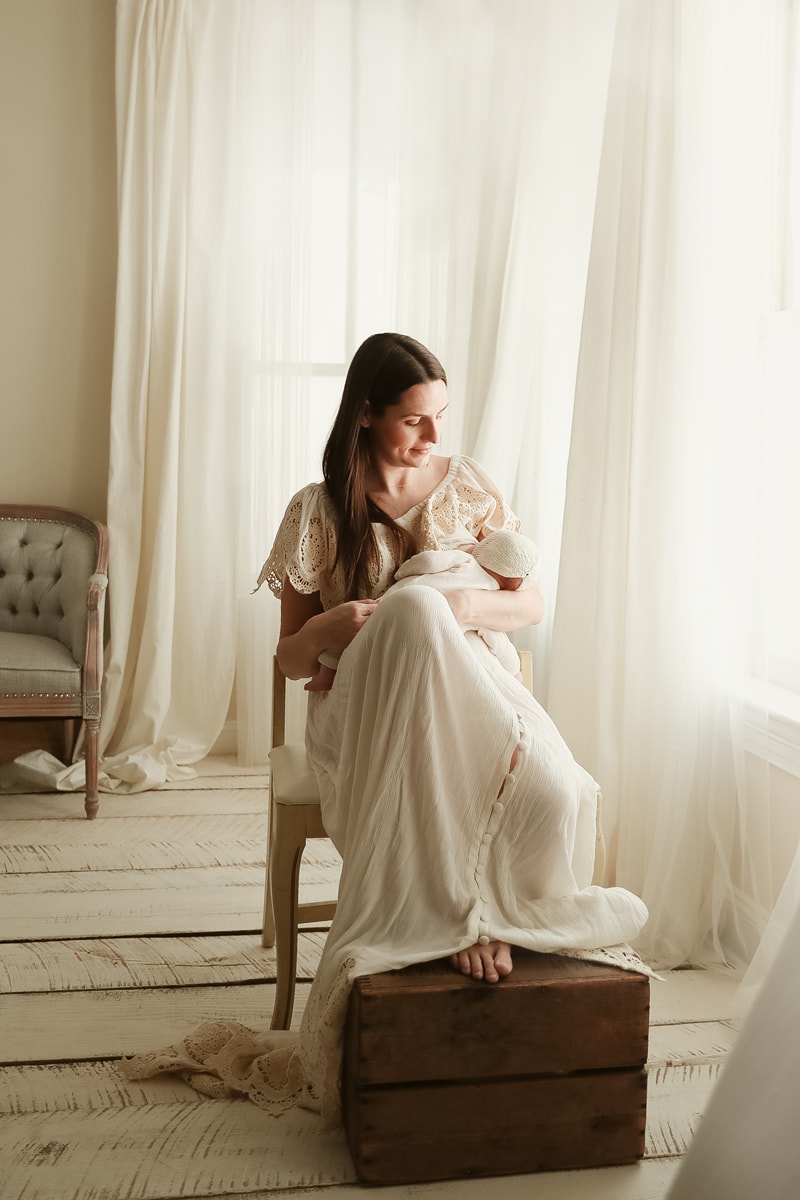 Lifestyle Photographer, A mother sits to breastfeed her child