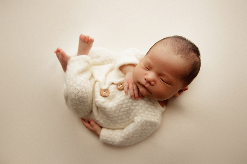 Newborn Photographer, a little baby sleeps in knit onesie