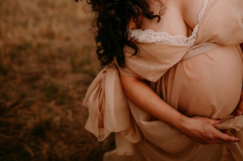 Fine Art Maternity Photographer, a mother-to-be wears a chiffon dress ou=tdie