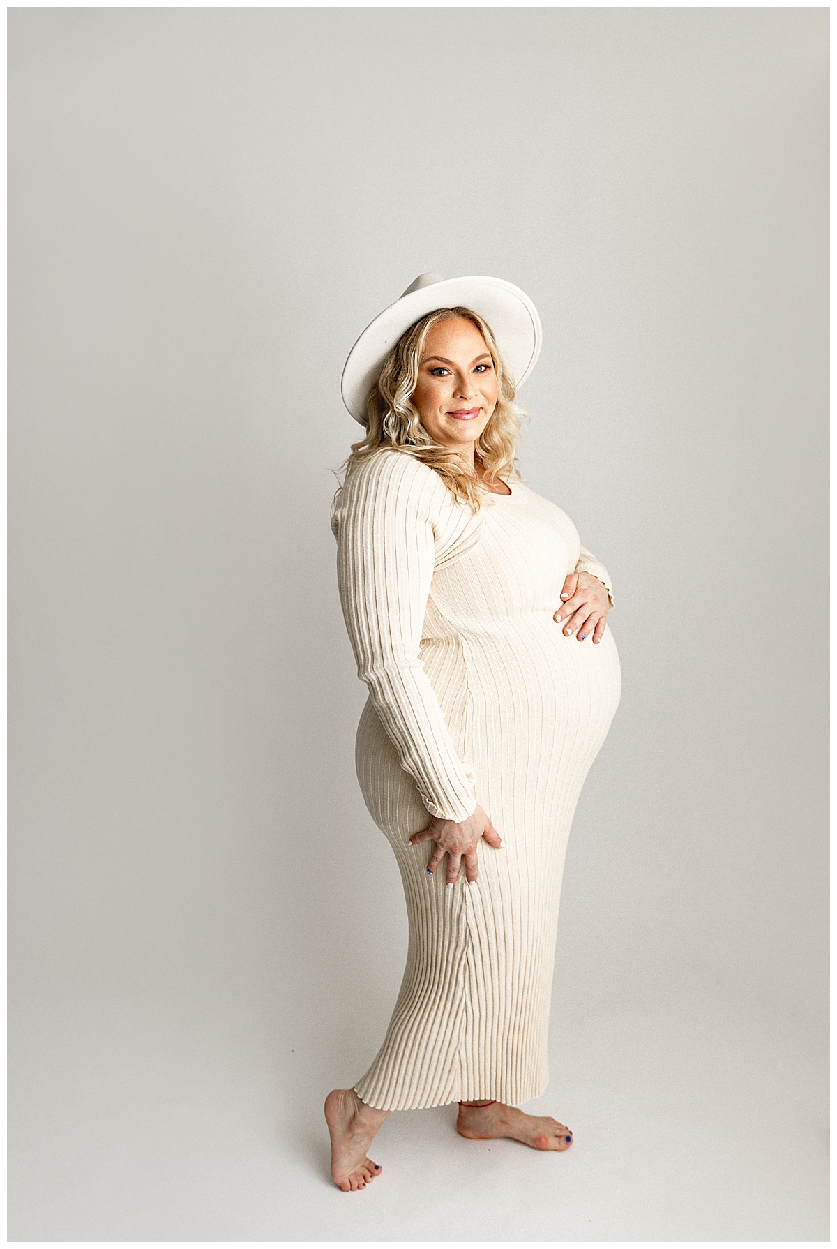 Woman with white long sleeve maxi dress for IVF Maternity Session.