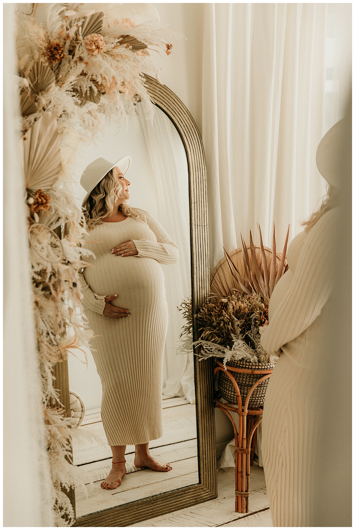 Mama to be looks out to window in front of mirror for Washington DC Maternity Photographer