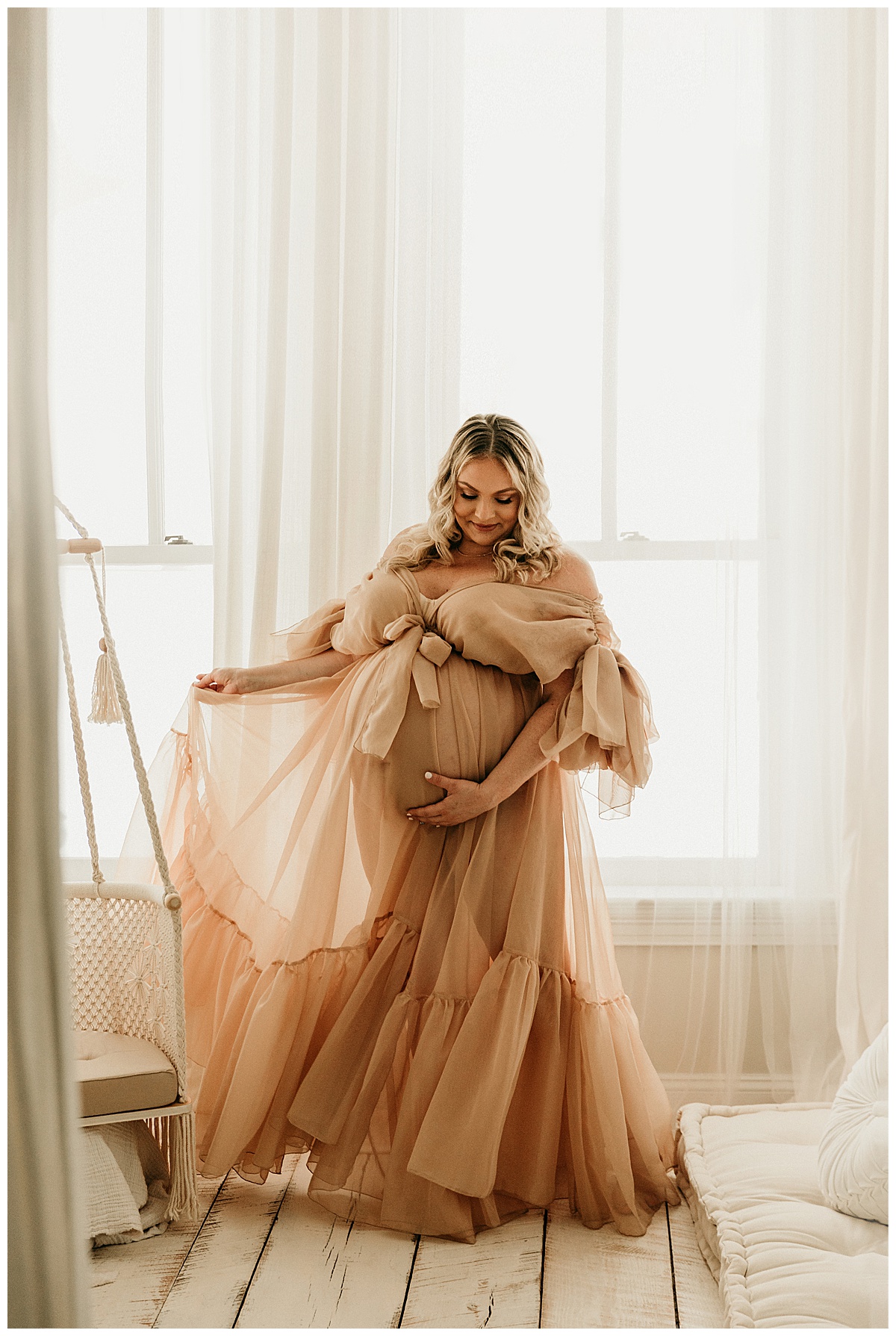 Woman twirls with dress holding pregnant belly for IVF Maternity Session.