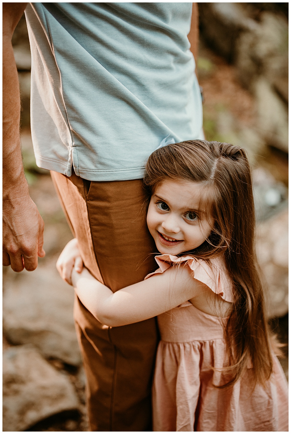 Baby girls hugs dad in Shenandoah Mountains