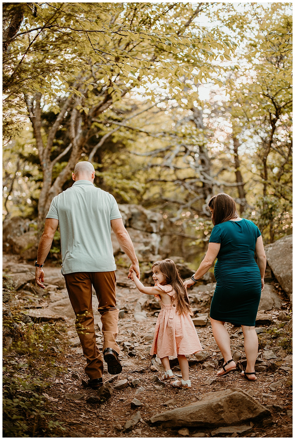 Family walking through woods for Washington DC Maternity Photographer 