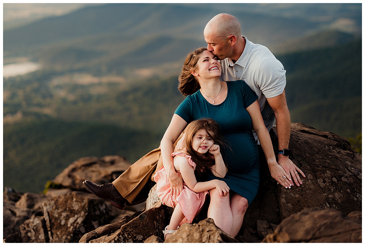 Dad kisses mom on rock for Norma Fayak Photography