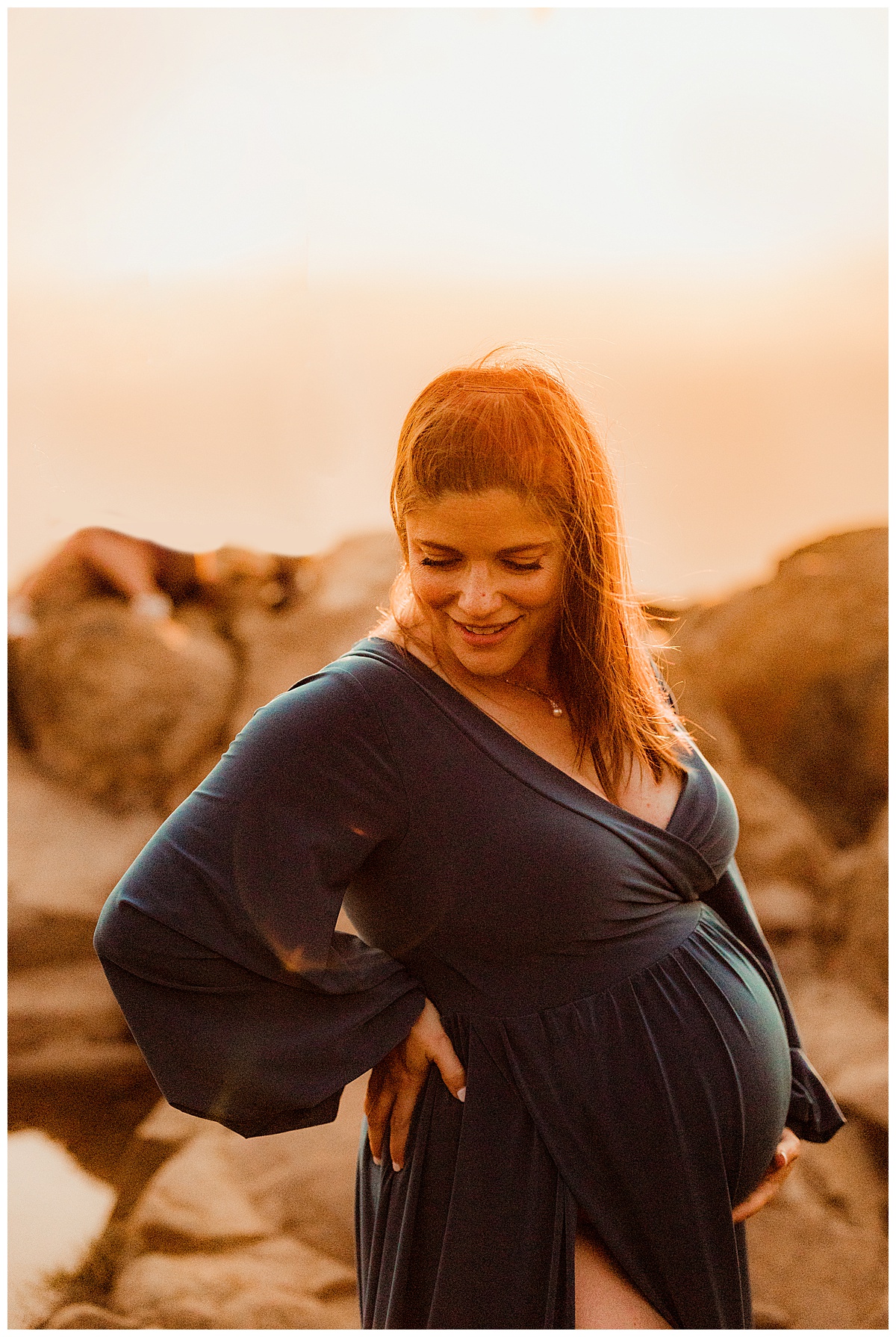Mom smiles down at belly during sunset for Washington DC Maternity Photographer 