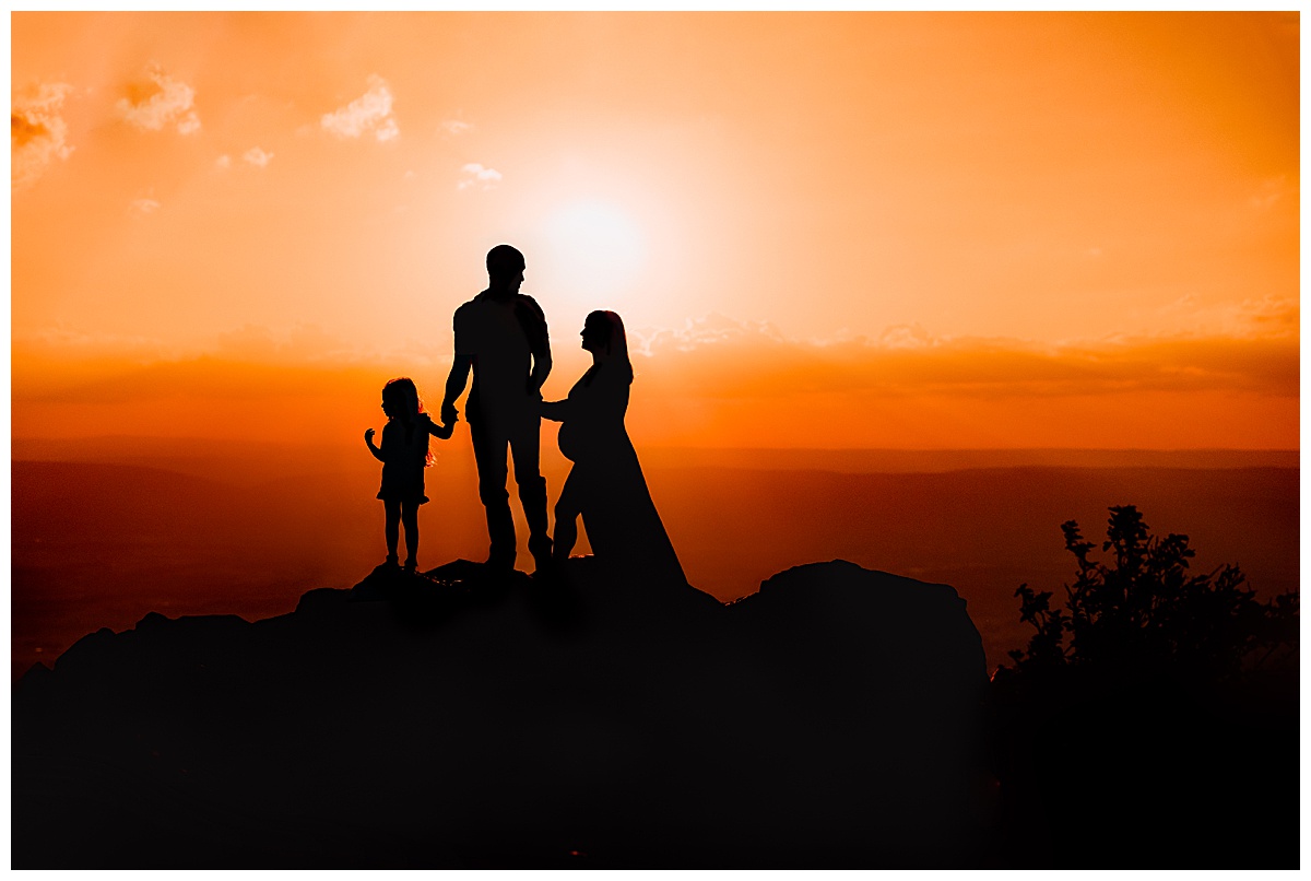Family embraces each other at sunset in Shenandoah Mountains