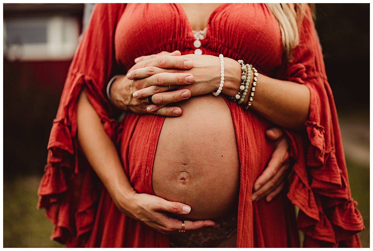 Pregnant belly embraced by Norma Fayak Photography