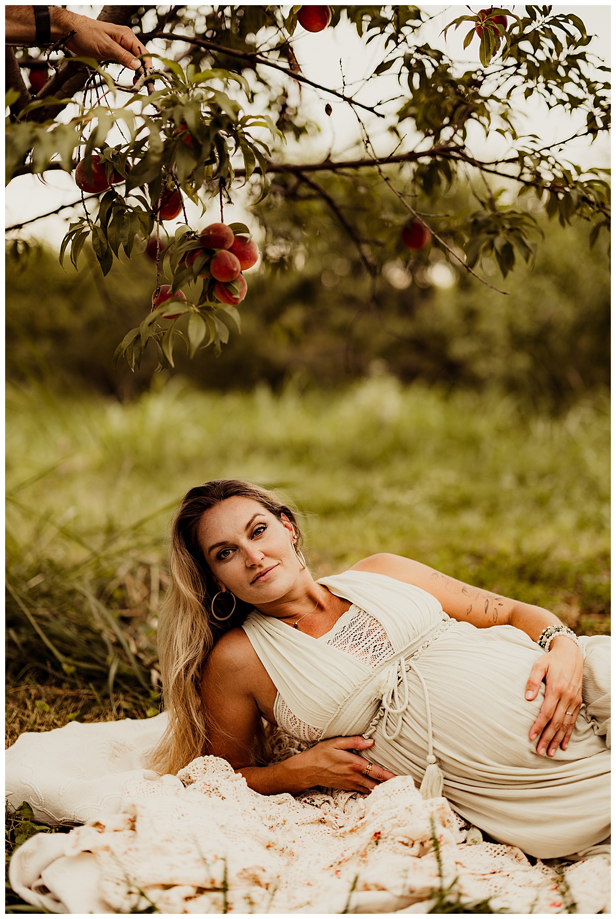 Mom laying down holding pregnant belly by Norma Fayak Photography