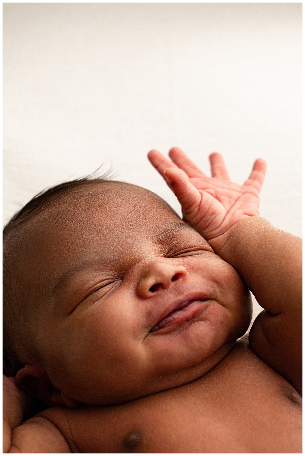 Baby has tiny hands by face for Norma Fayak Photography