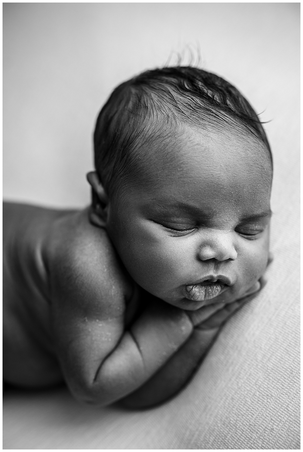 Baby boy lays on hands for Norma Fayak Photography
