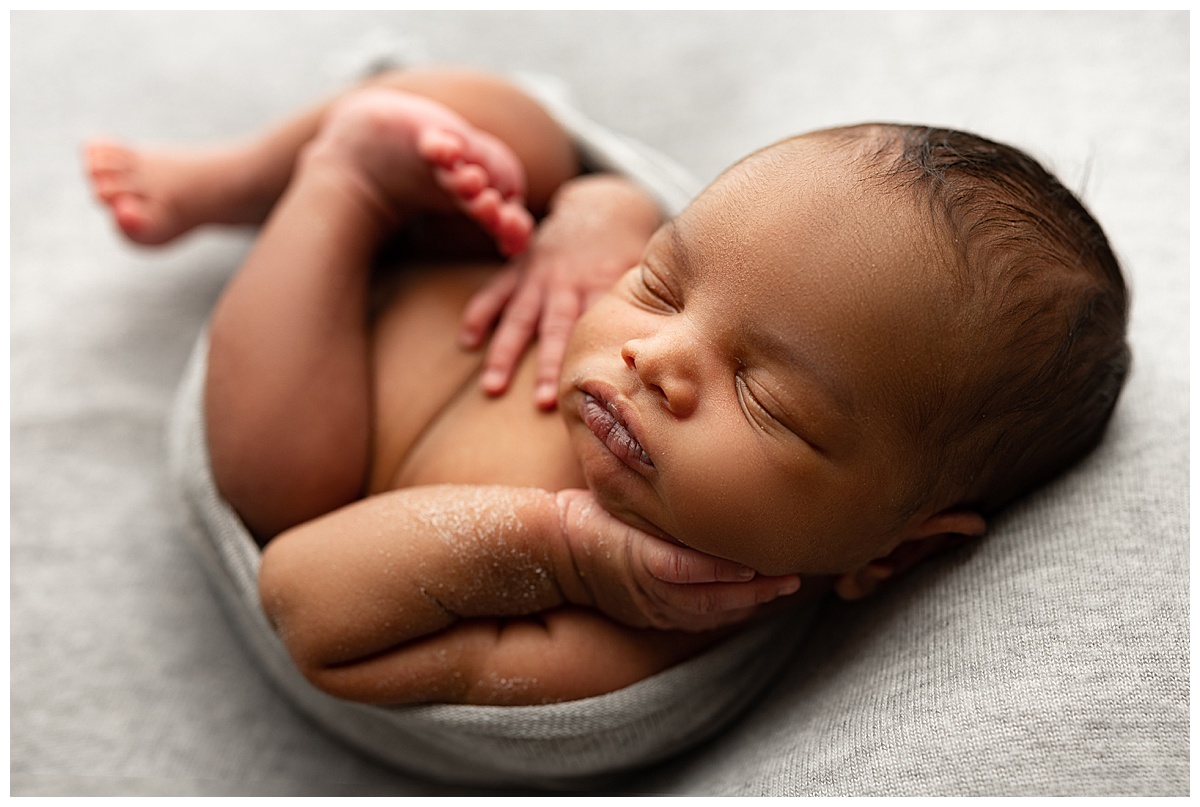 Little hand on cheek for Washington DC Newborn Photographer