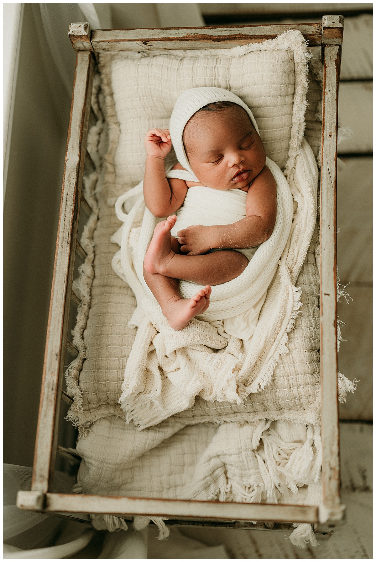 Newborn baby boy in cradle for Norma Fayak Photography