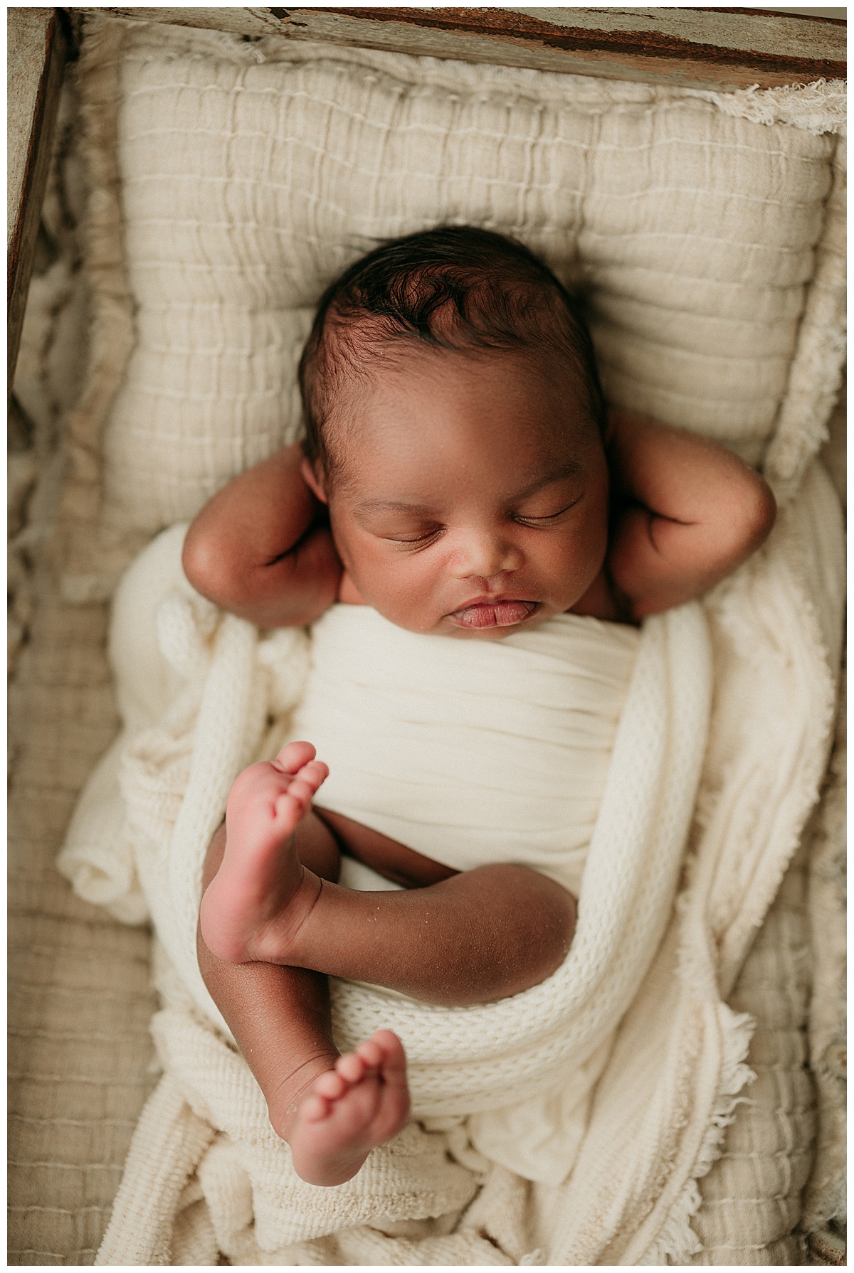 Newborn baby boy holds hands behind head for Occoquan, VA Newborn Studio