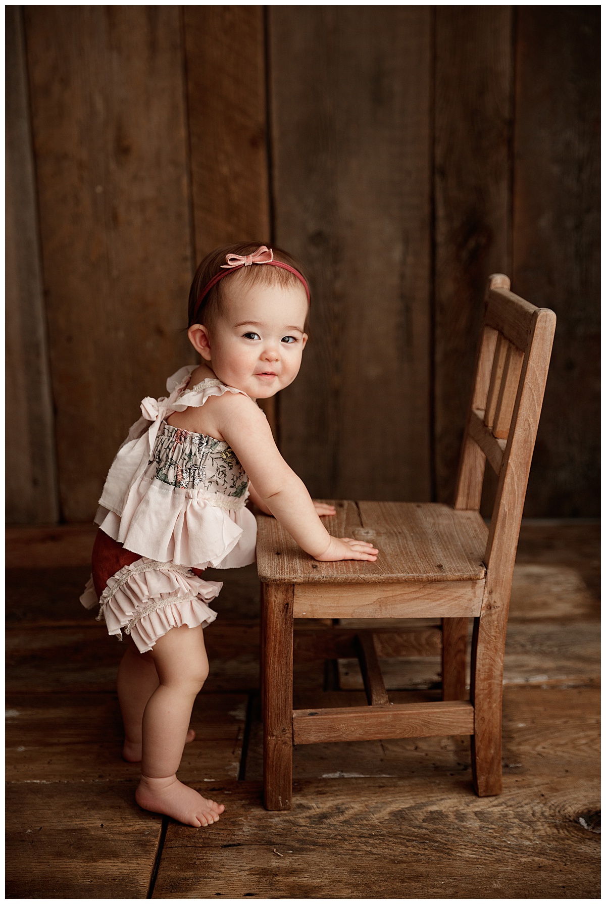 Baby leaning on chair bu Norma Fayak Photography