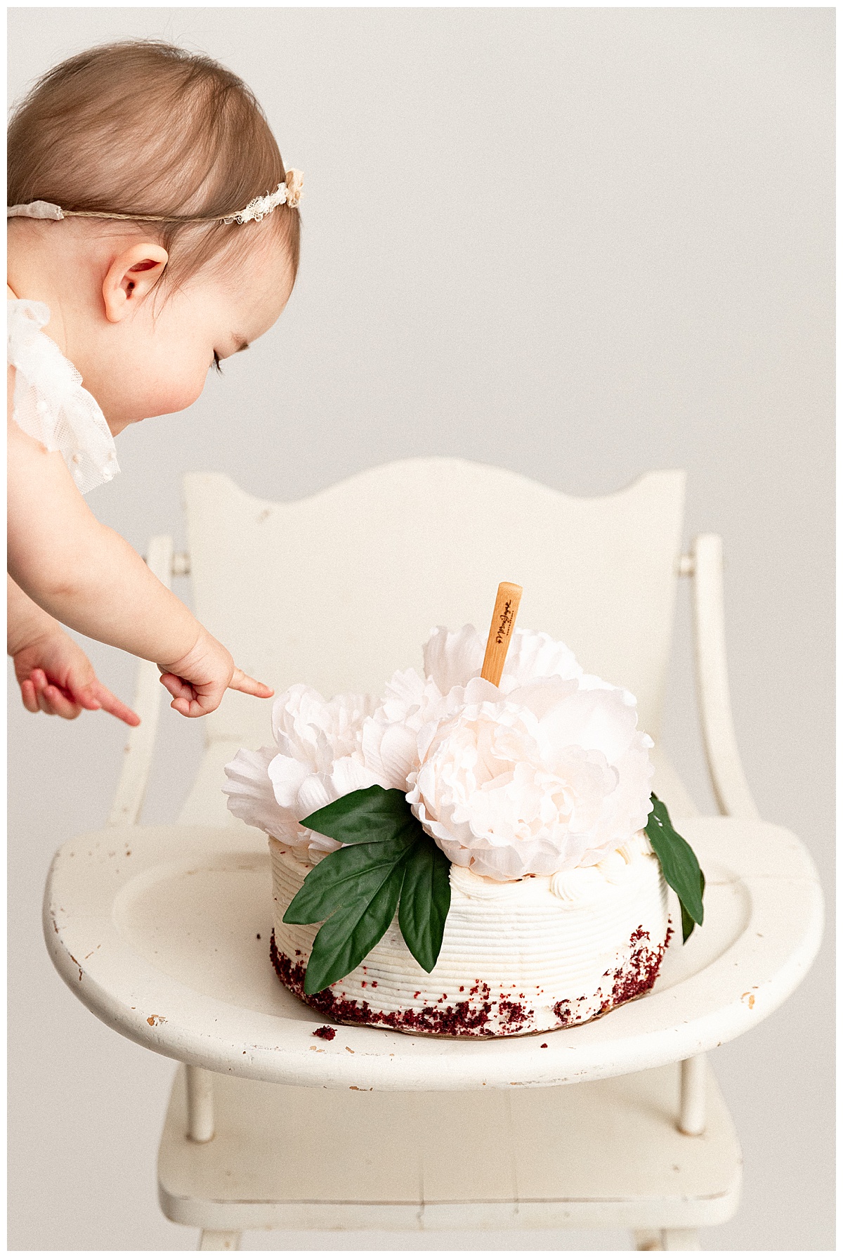 Baby reaching for cake forFirst Birthday Cake Smash