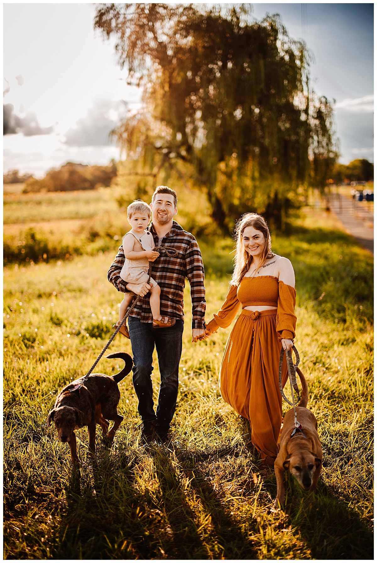Full family walks through grass by Norma Fayak Photography