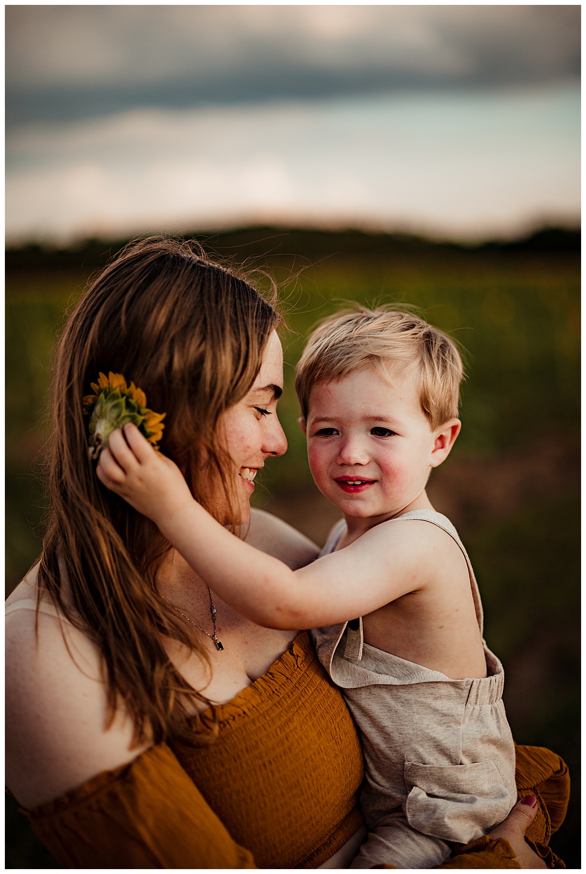 Mom and son have a moment in Sunflower Field 