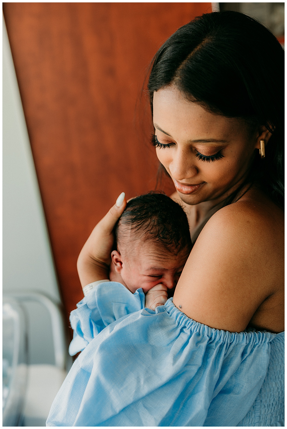 Mom holds baby on chest for Washington DC Newborn Photographer
