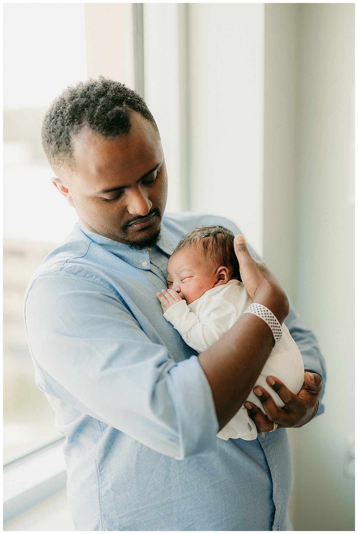 Dad holds infant close for Fresh 48 Hospital Session