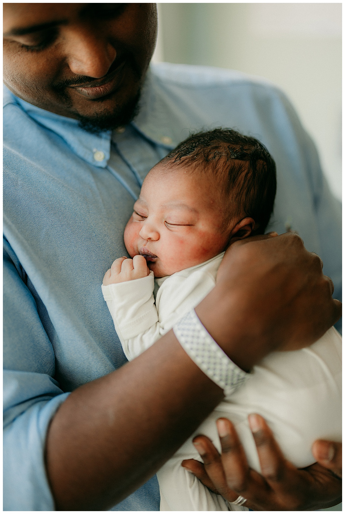 Little baby cuddles on dads chest for Washington DC Newborn Photographer