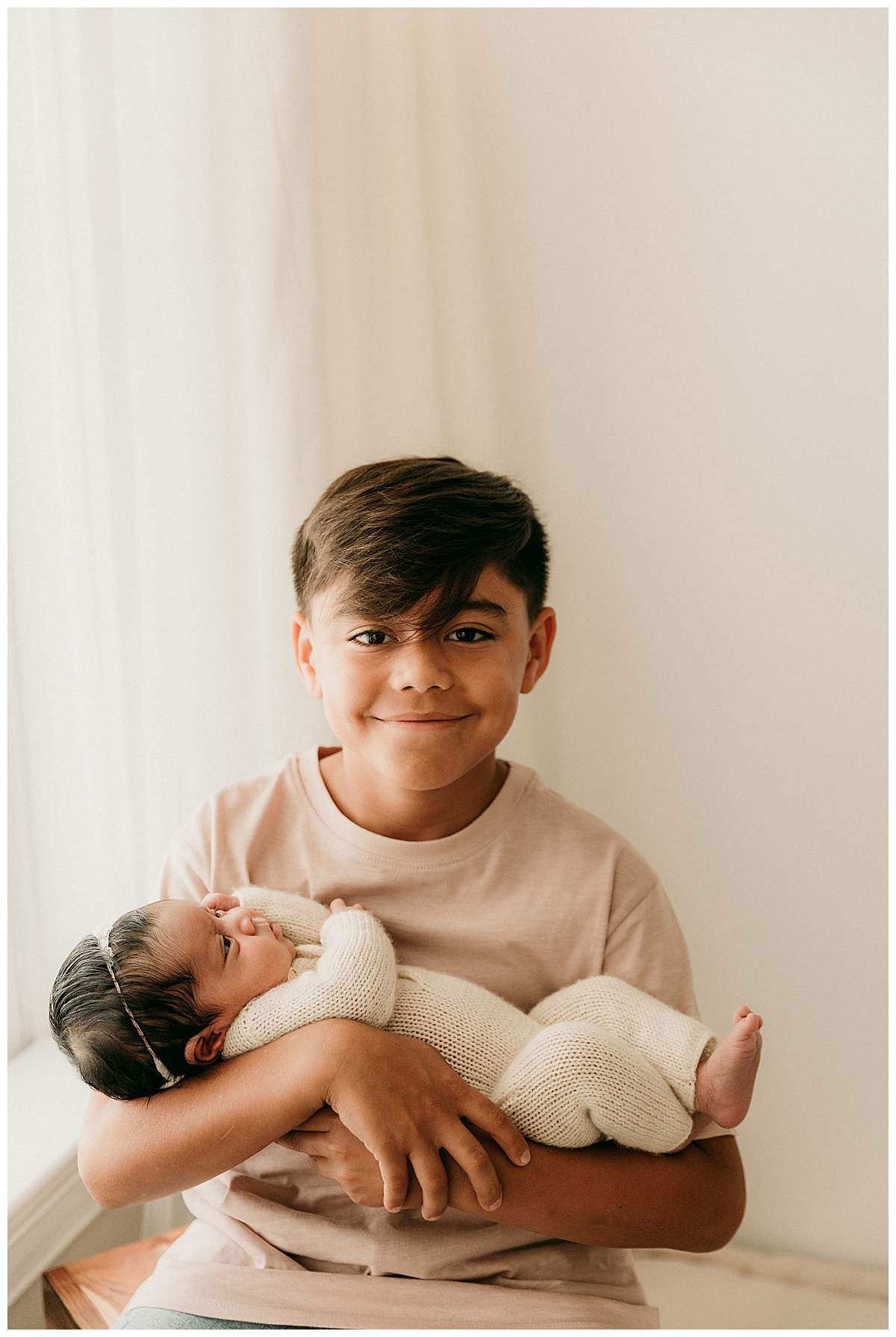 Older brother holds baby sister close for Norma Fayak Photography
