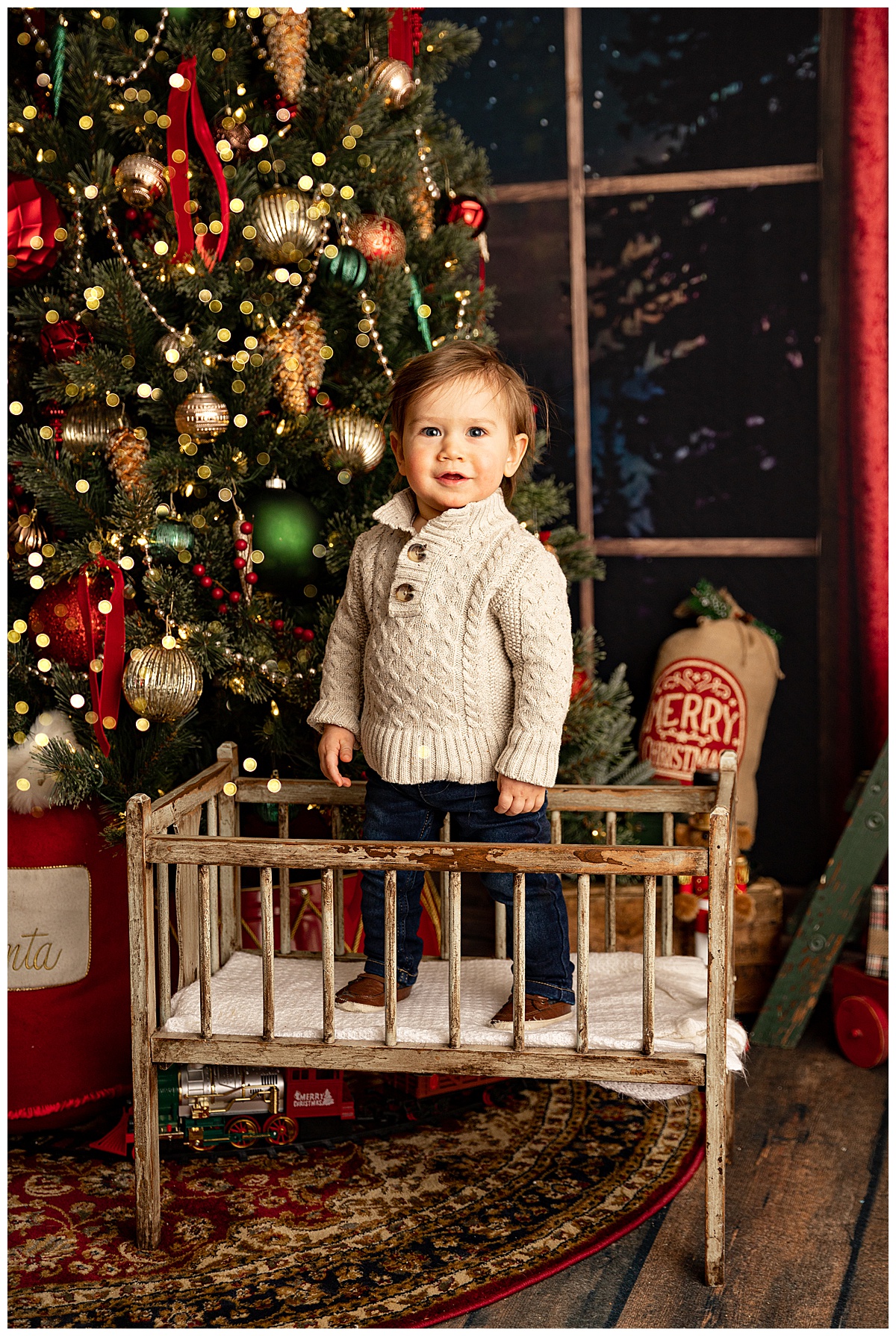 Little one stands in bassinet after Meeting Santa