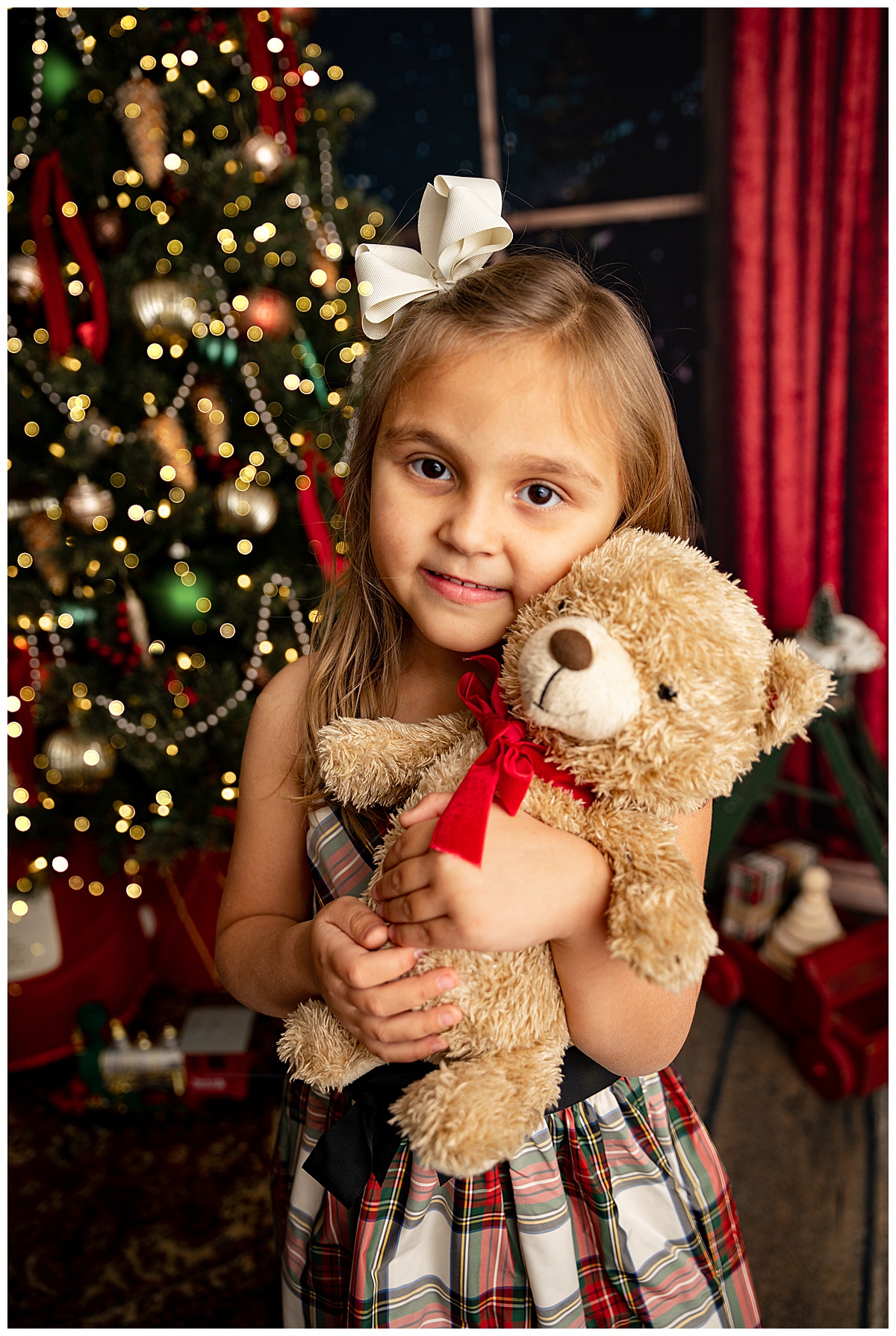 Young girl hugs teddy bear for Norma Fayak Photography