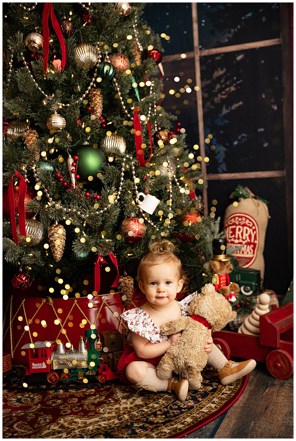 Baby sits by tree before Meeting Santa