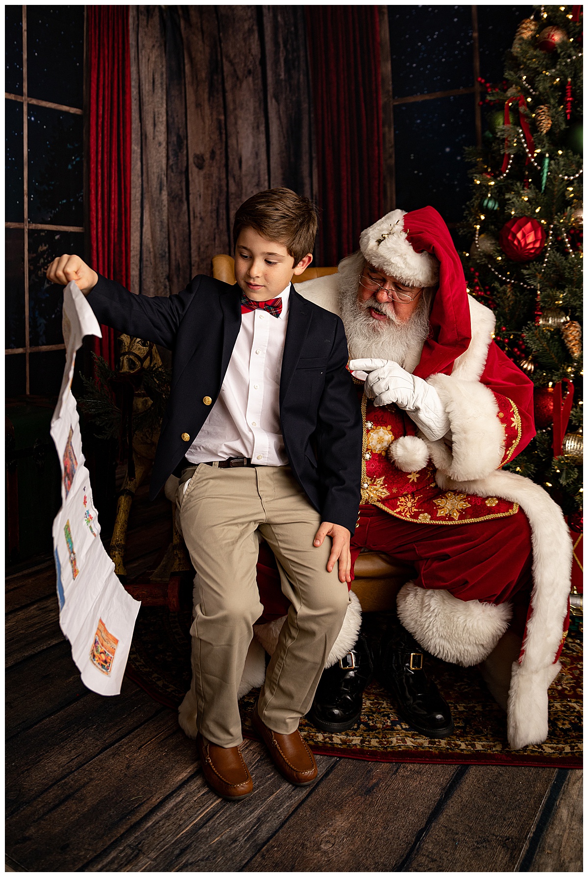 Boy shows Christmas list to Santa for Norma Fayak Photography