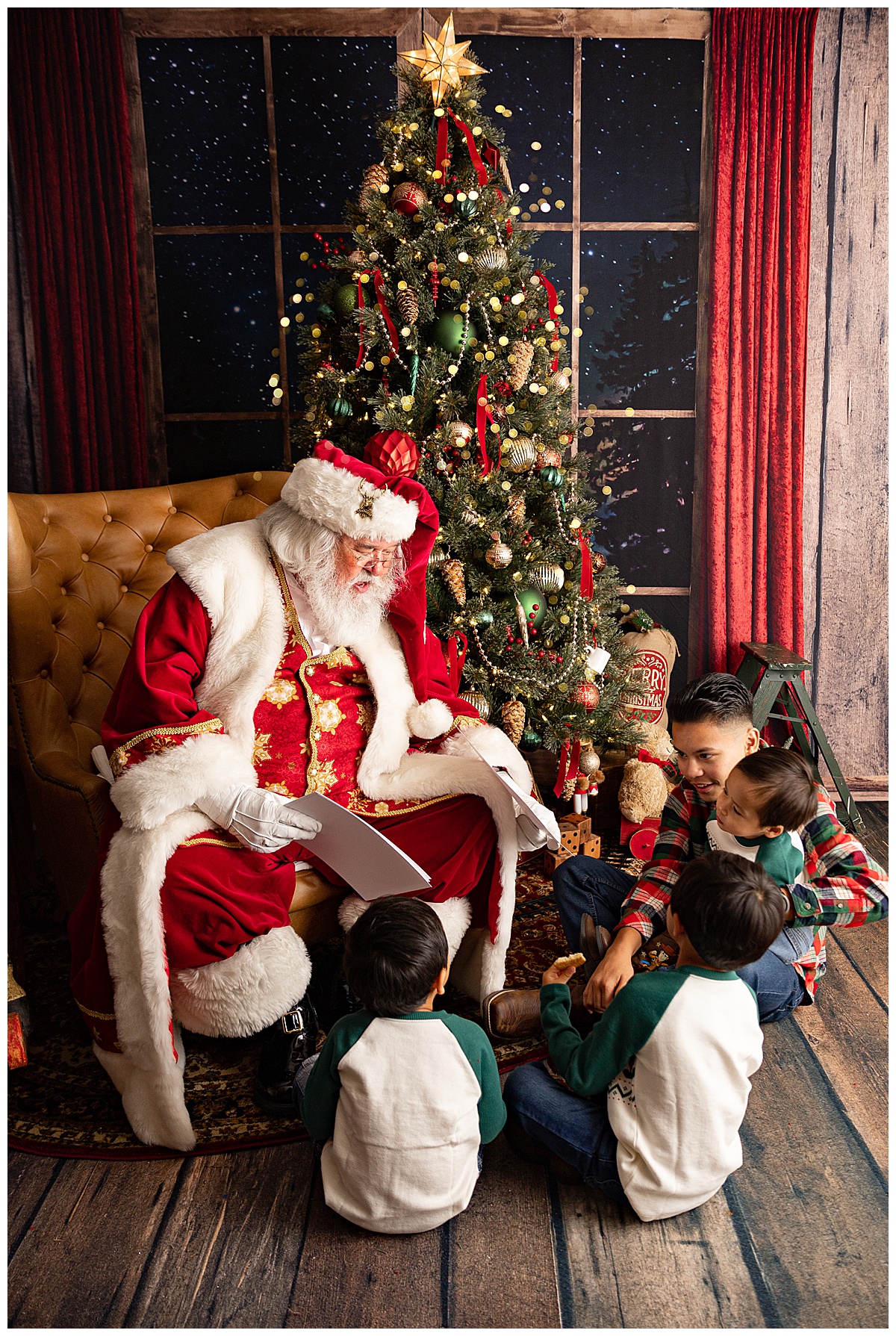 Family sits in front of Santa to read book for Norma Fayak Photography