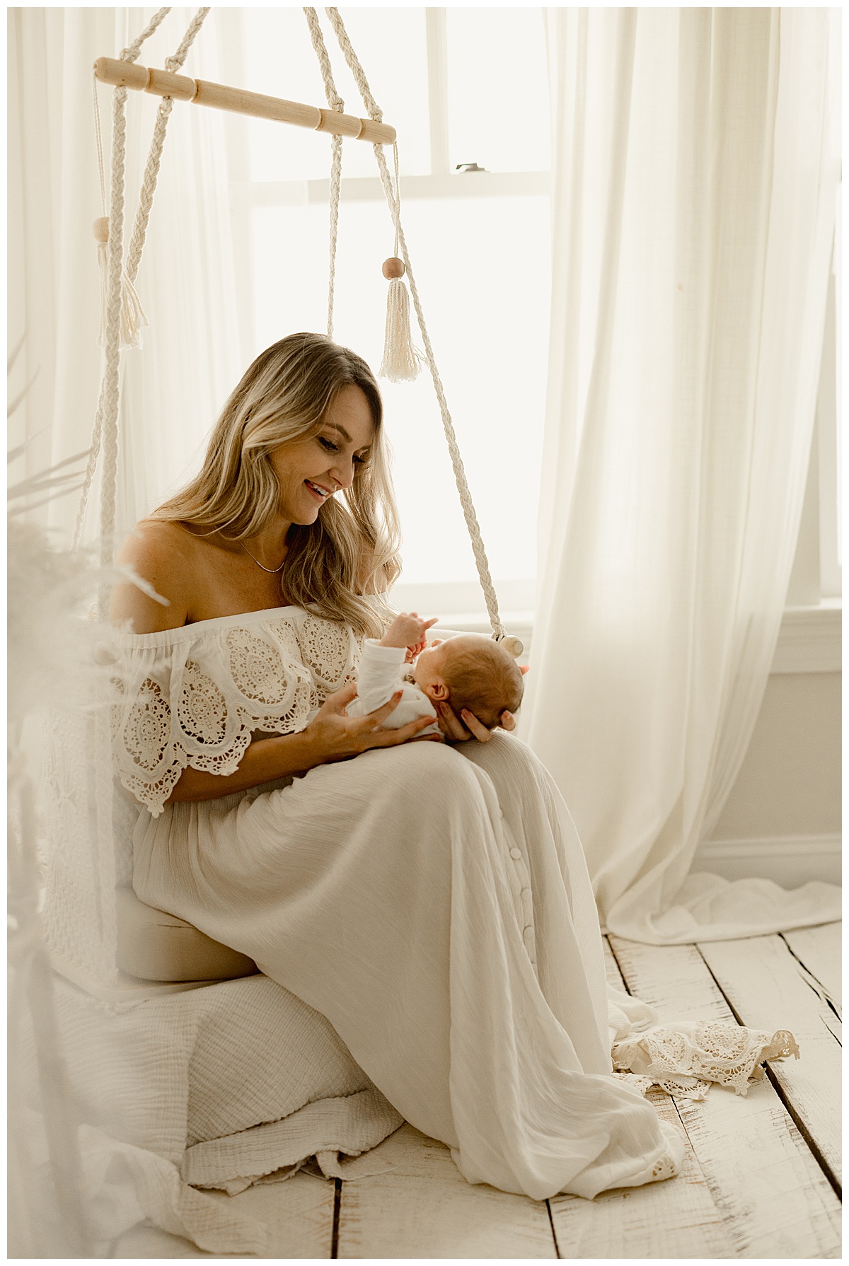 New mom admiring son for Washington DC Newborn Photographer