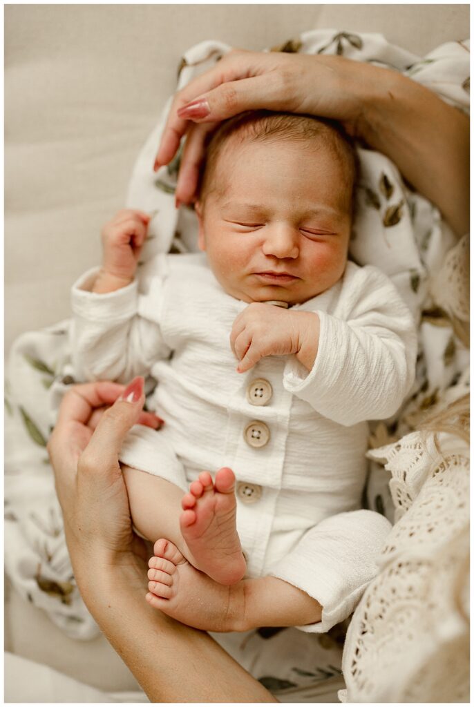 Baby being cuddled by mom for White Room Newborn Session