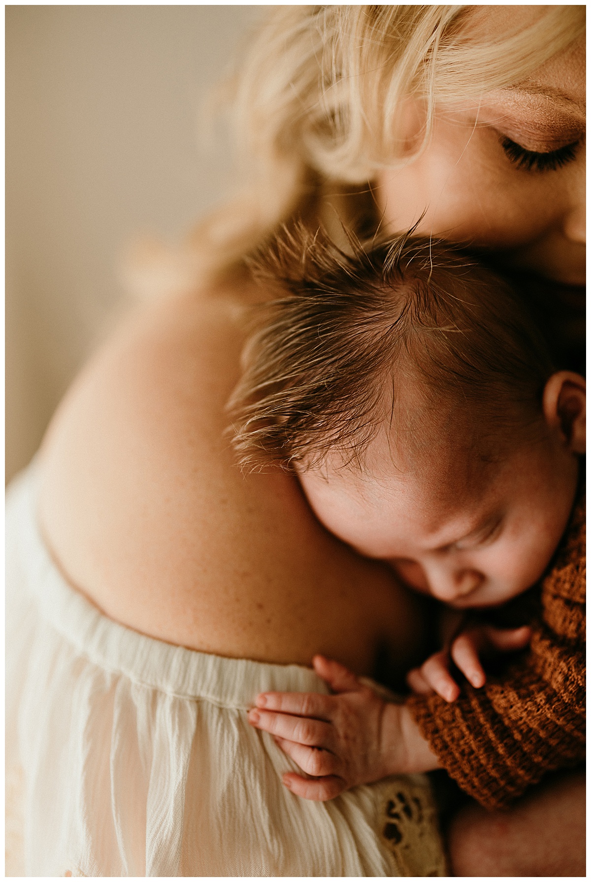 Little one lays on moms shoulders for Washington DC Newborn Photographer