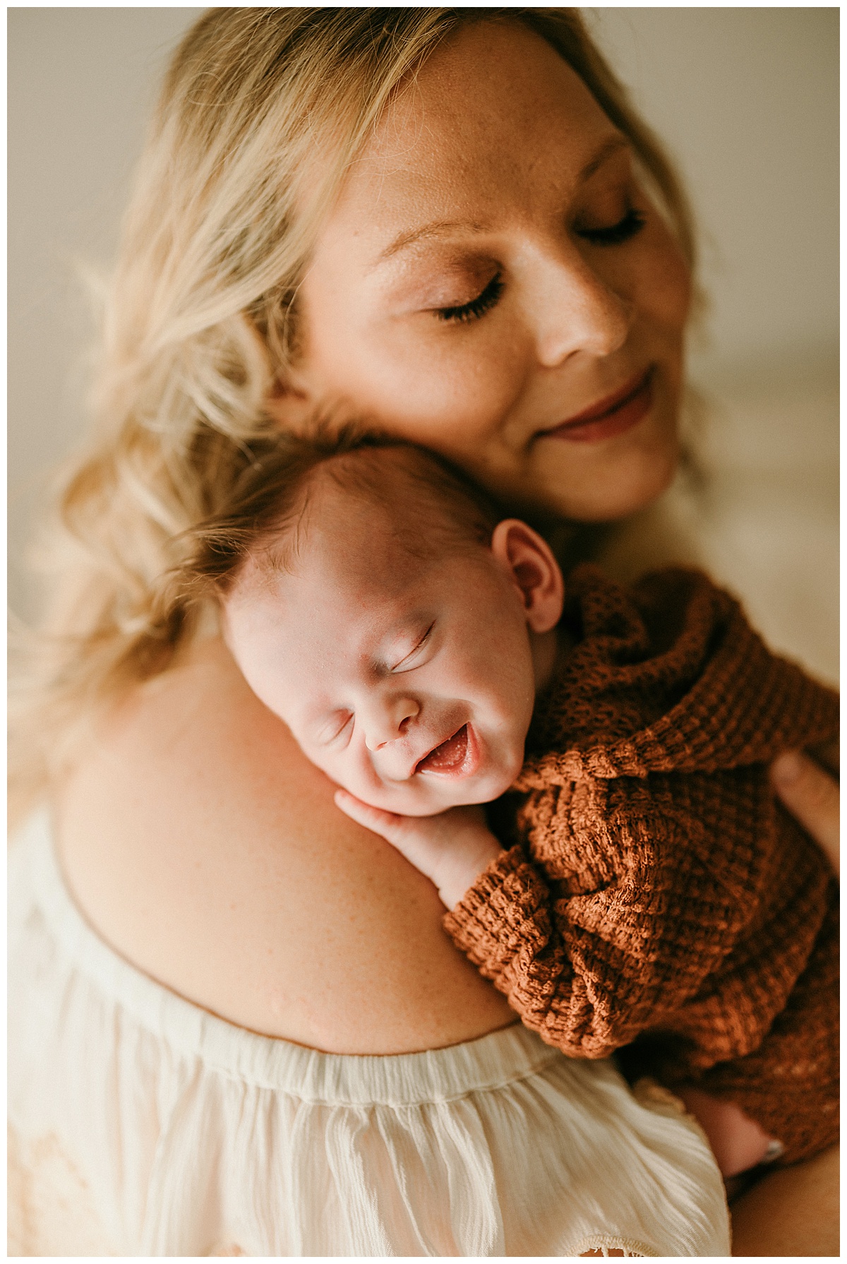 Infant smiles on mom for Washington DC Newborn Photographer