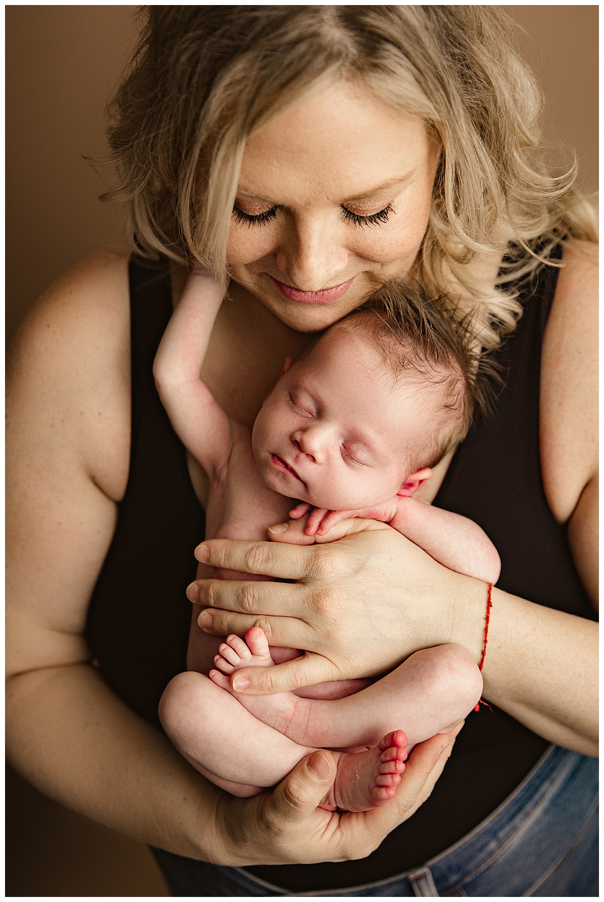 infant holds onto mama for Norma Fayak Photography