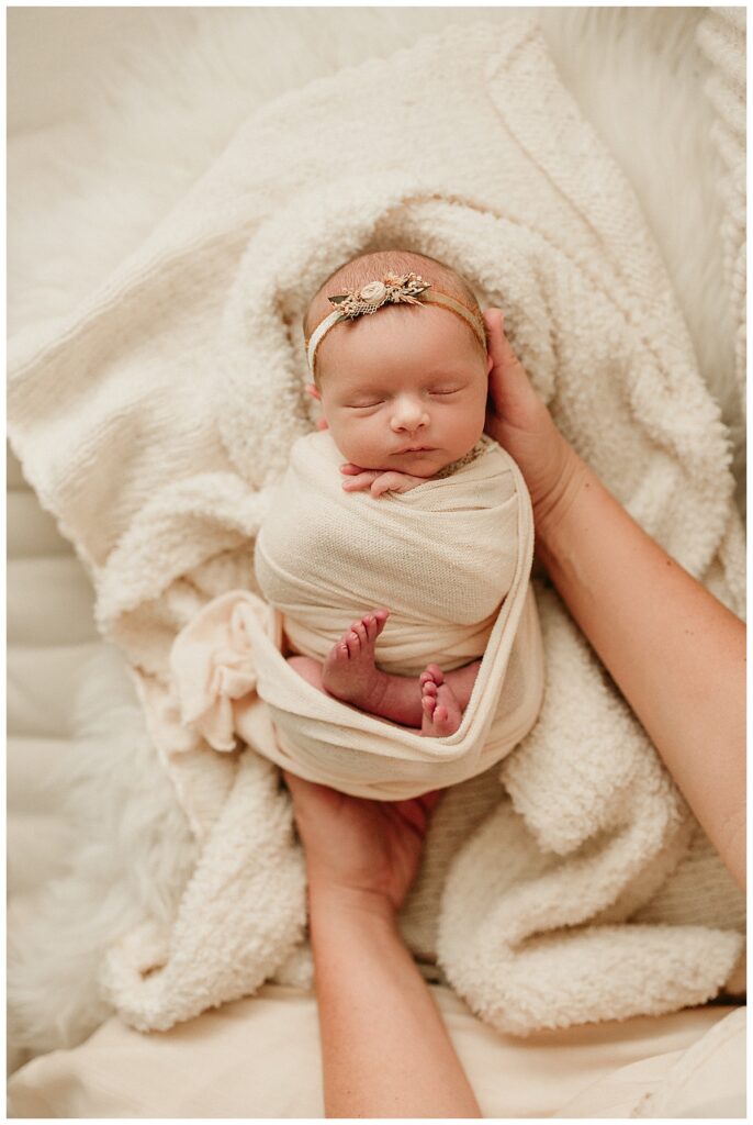 Baby being held for Washington DC Newborn Photographer
