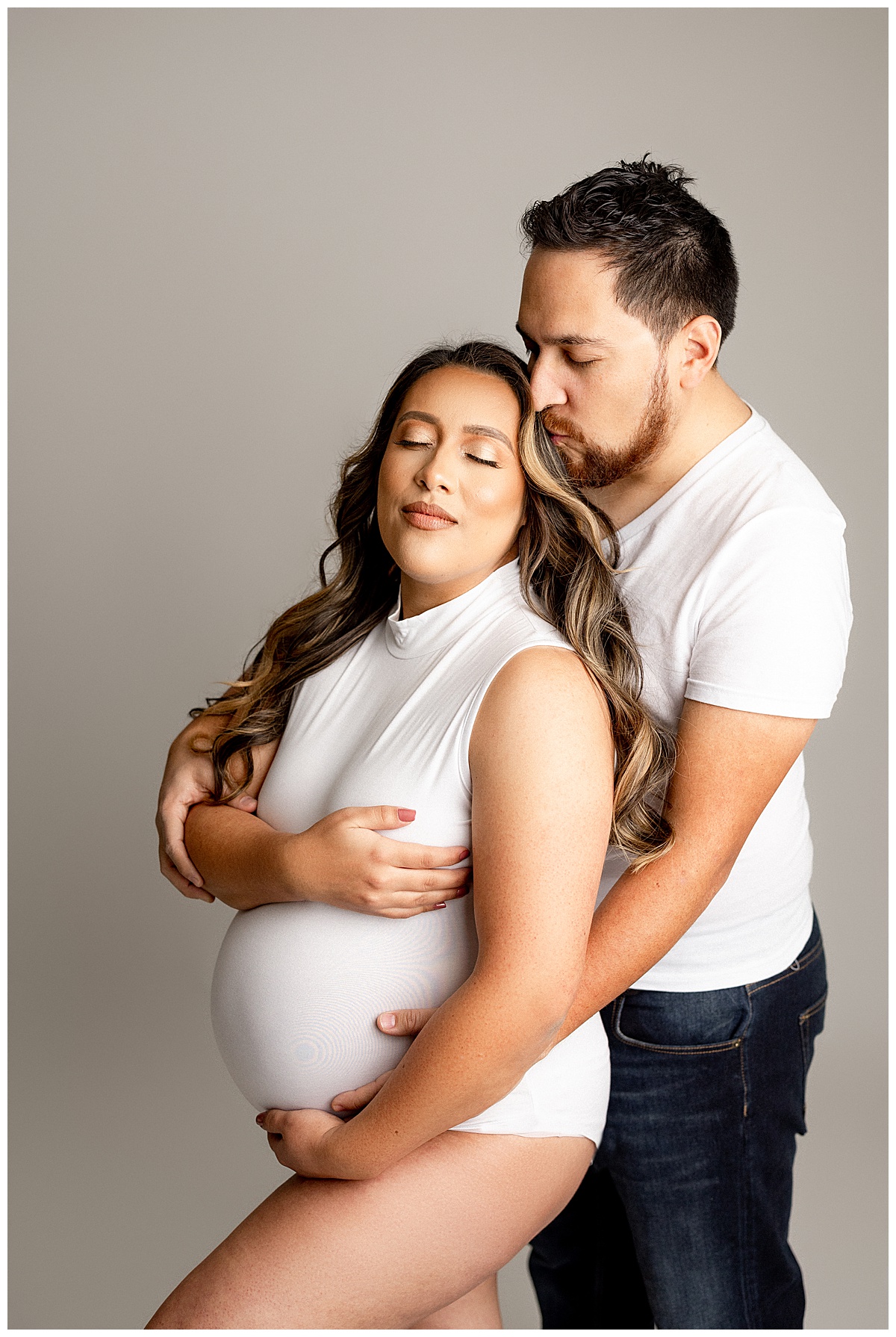 Dad loves on mom for Studio Maternity Session