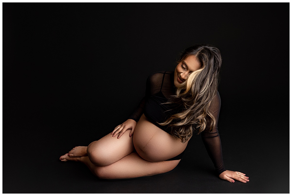 Female leans over with pregnant belly for Virginia Newborn Photographer