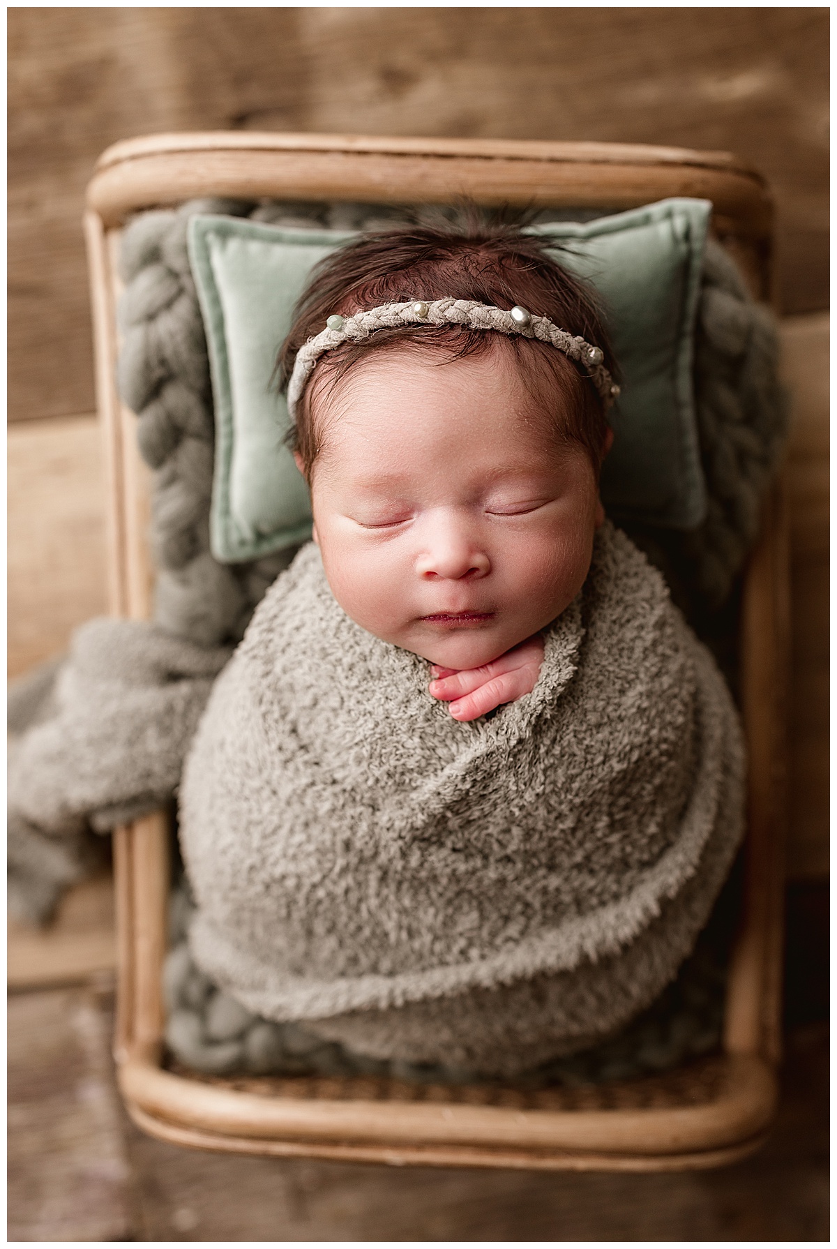 Infant sleeps wrapped in tight swaddle for Norma Fayak Photography