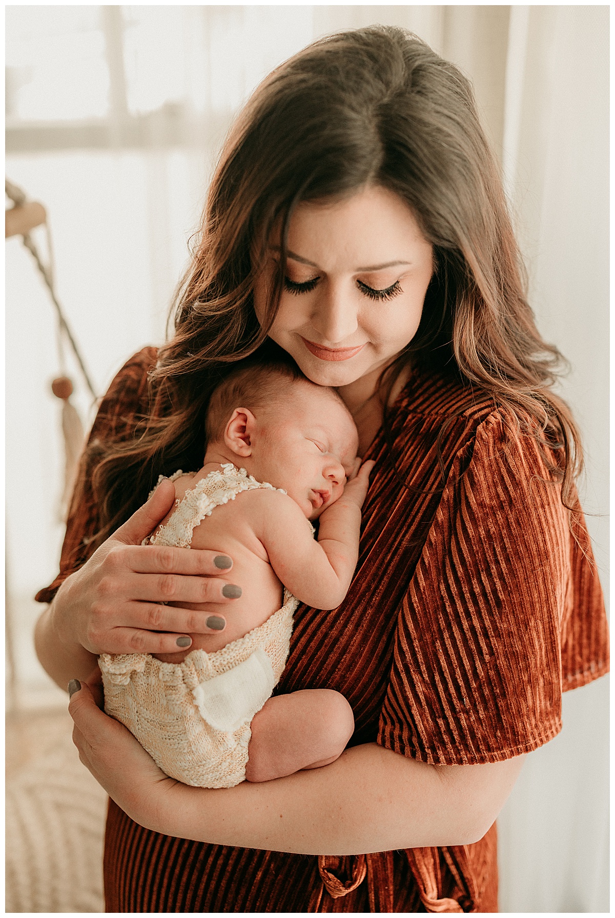 Mother holds baby on her chest for Intimate Studio Newborn Session