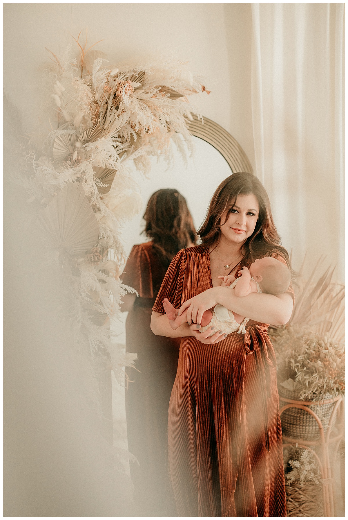 Mom and baby stand on front of mirror for Norma Fayak Photography