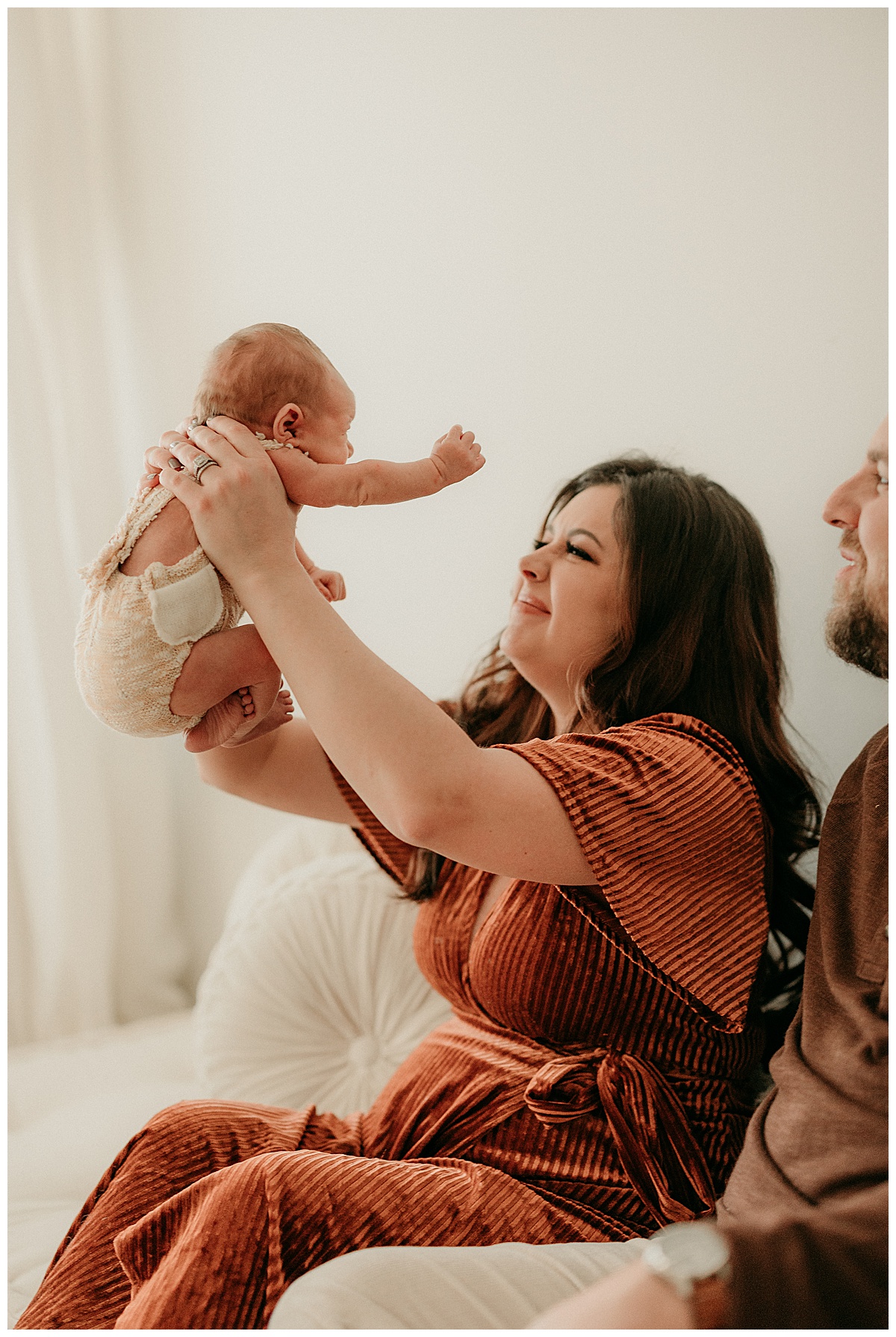 Infant is held by parents for Intimate Studio Newborn Session