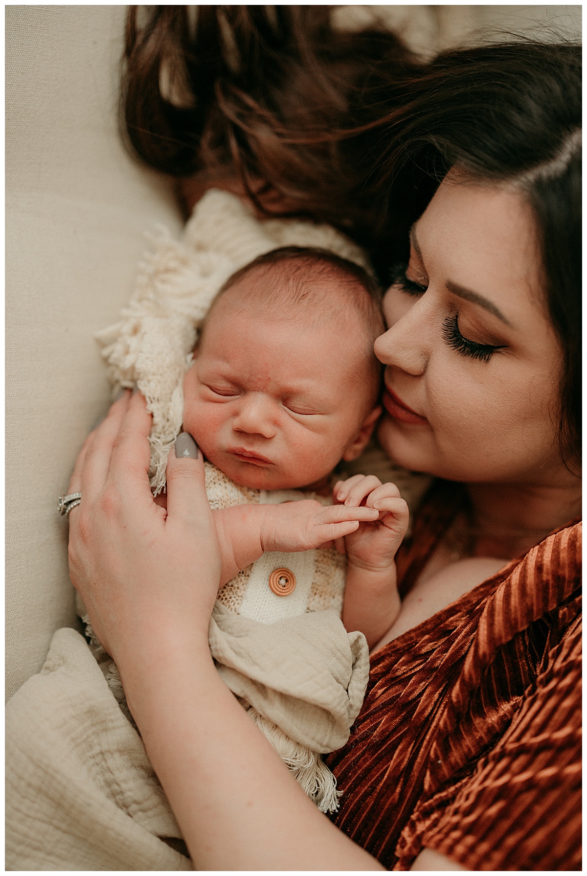 Mama kisses baby boy during Intimate Studio Newborn Session